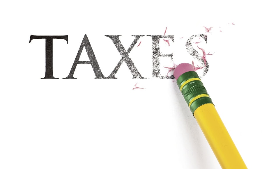 Tax removal eraser destroying the word taxes for debt relief.