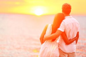 Sunset couple embracing at the beach in Long Island, New York.