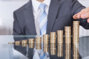 Stacks of coins increasing in height representing financial growth or savings.