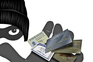 Credit cards, ID, and financial documents held by a woman with a focus on financial hardship assistance.