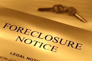 Foreclosure notice document with a key in the background, legal notice for homeowners facing property foreclosure.