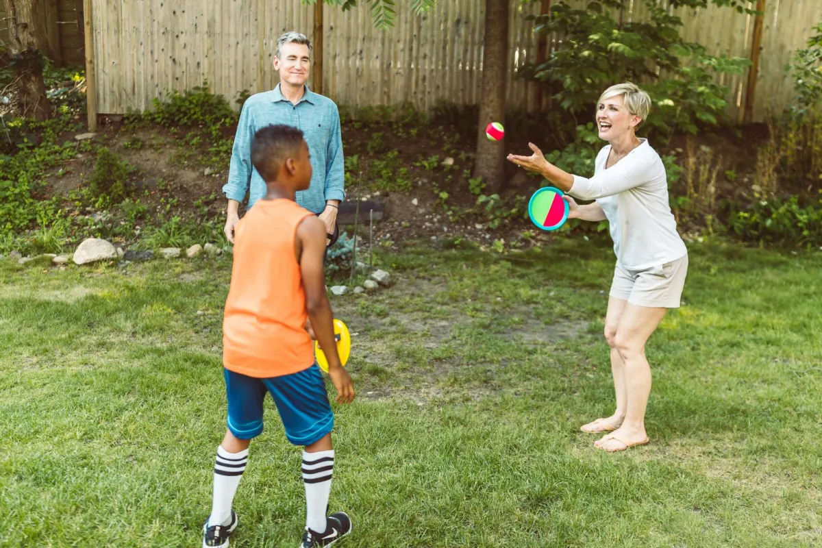 A happy family enjoying playtime together in the sunny backyard of their home