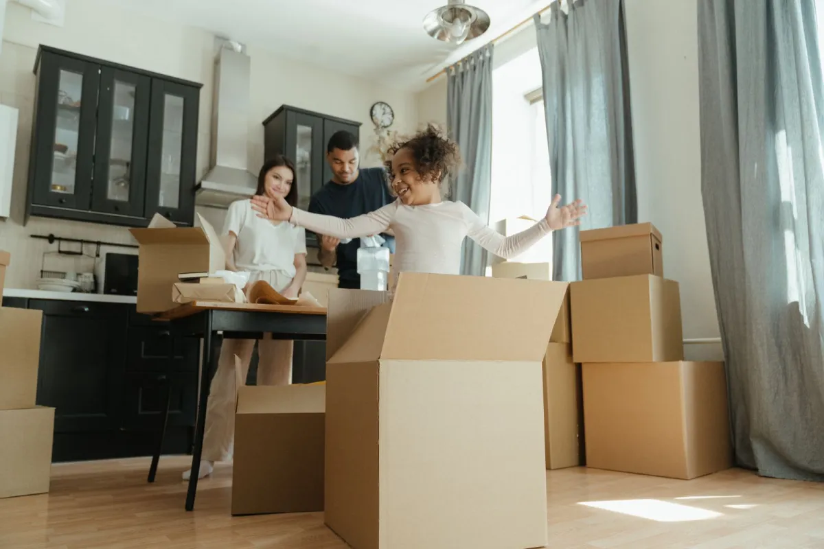 A joyful family unpacking moving boxes together as they settle into their home