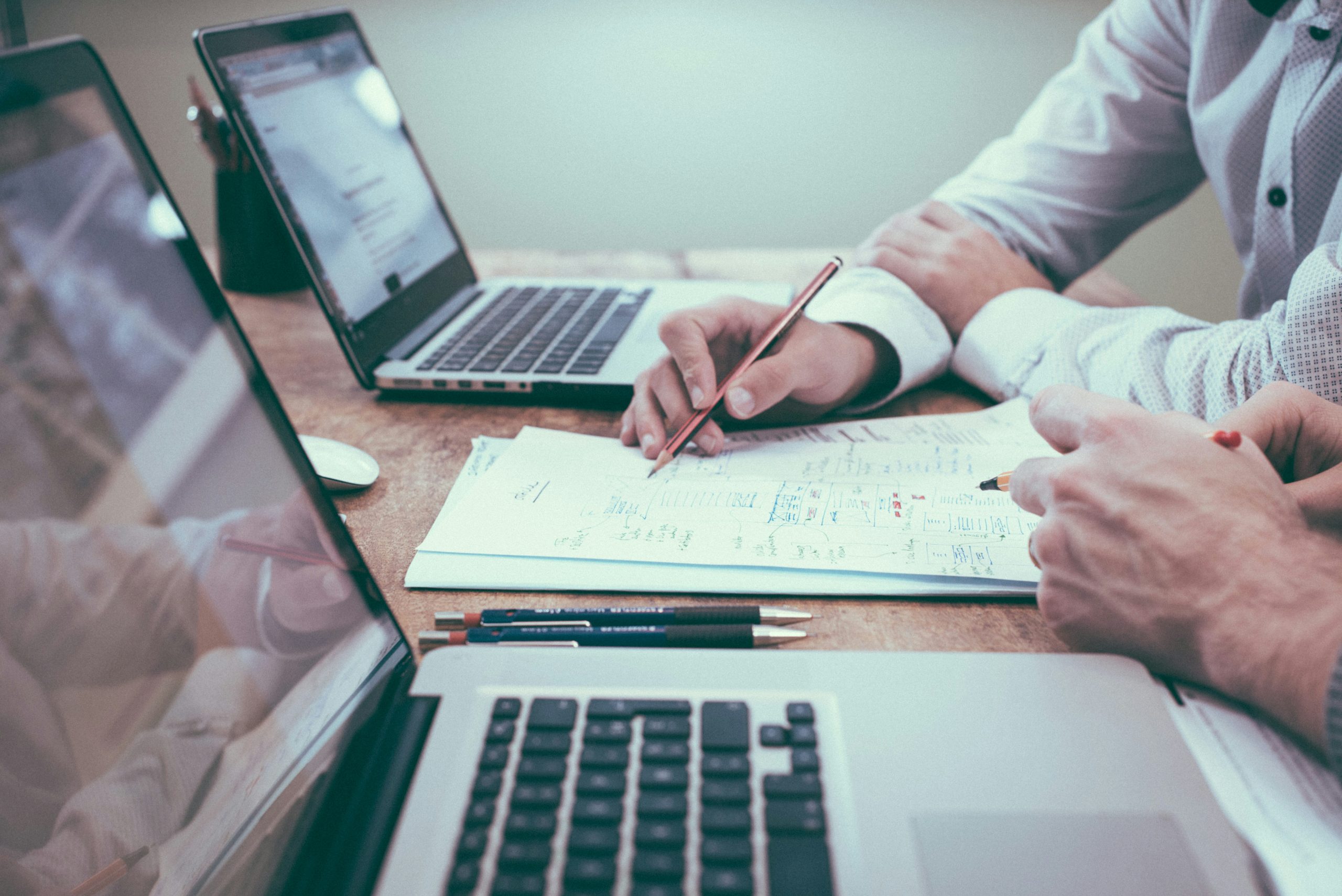 Two professionals at a desk collaborate, with Bankruptcy Attorneys Long Island & NYC reviewing documents.