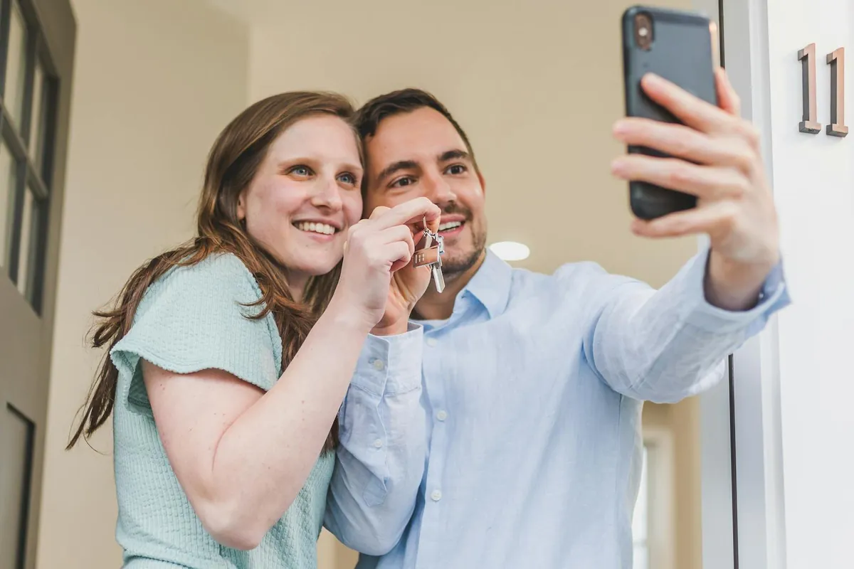 A couple celebrating with house keys at their new home