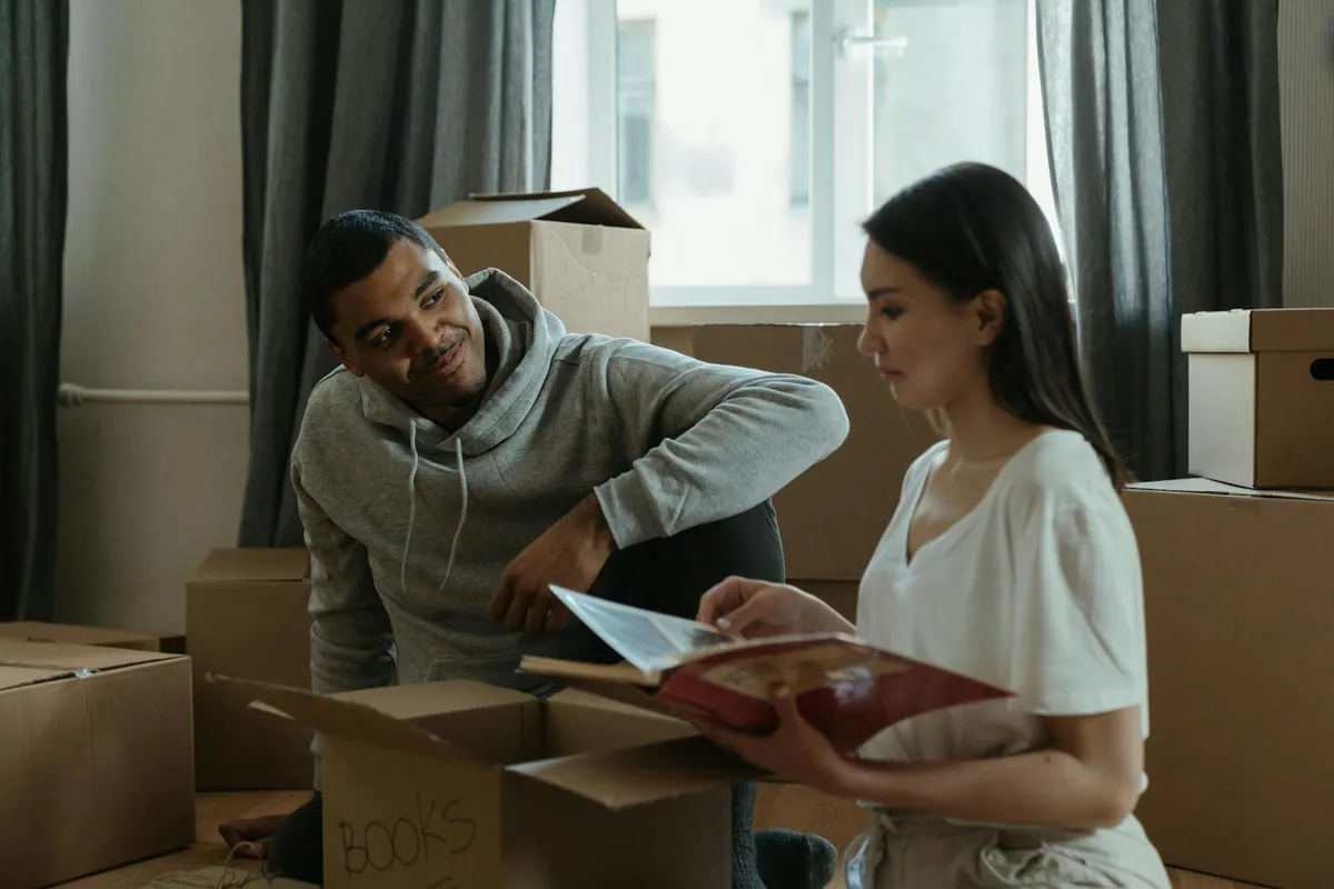 A couple unpacking boxes together as they settle into their home