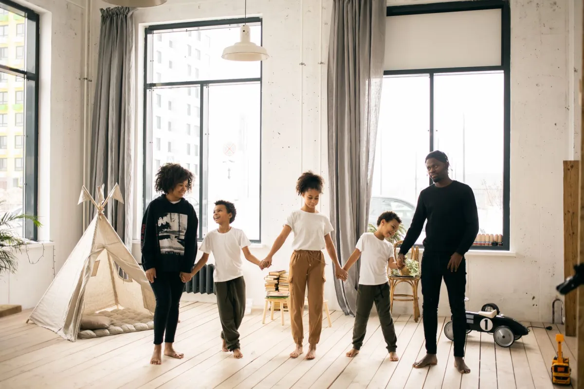 Family together by a bright window at home