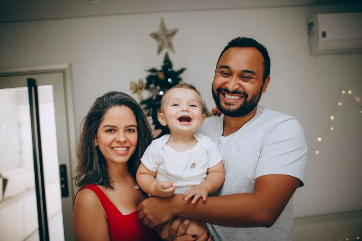Smiling family with their baby at home